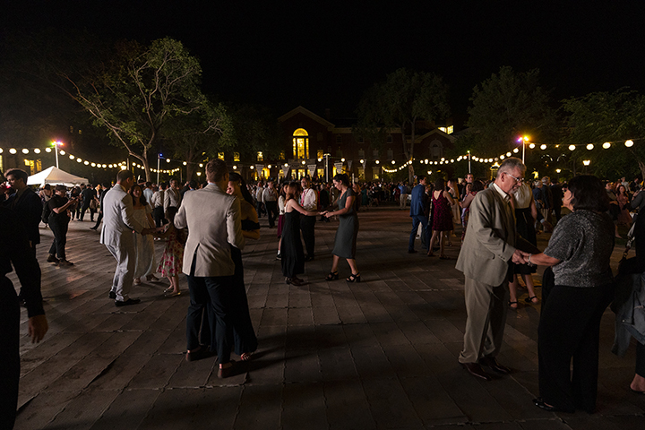 People dancing outside at night