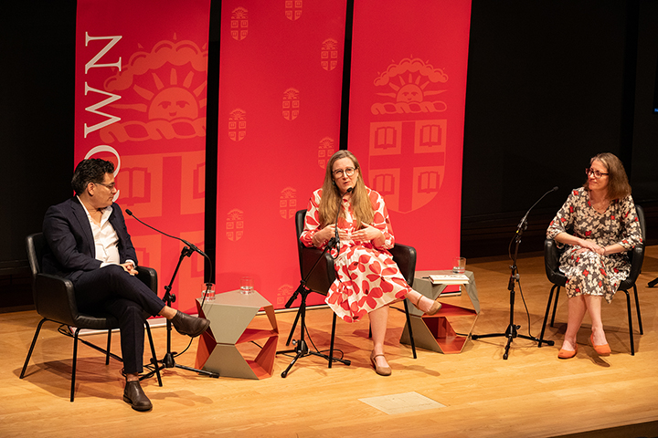 Forum speakers sitting on a stage