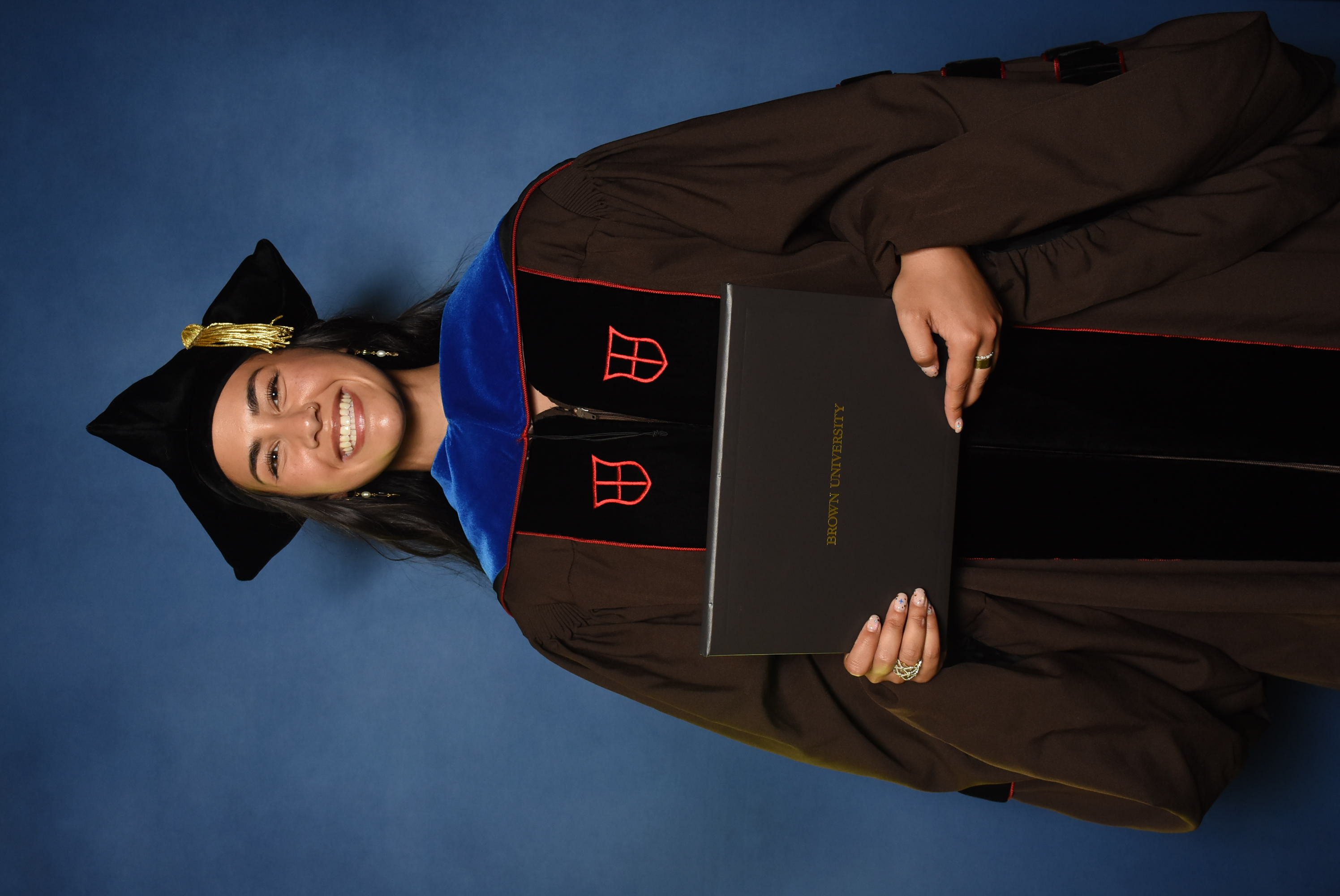 Another doctoral student poses for their official graduate photo.